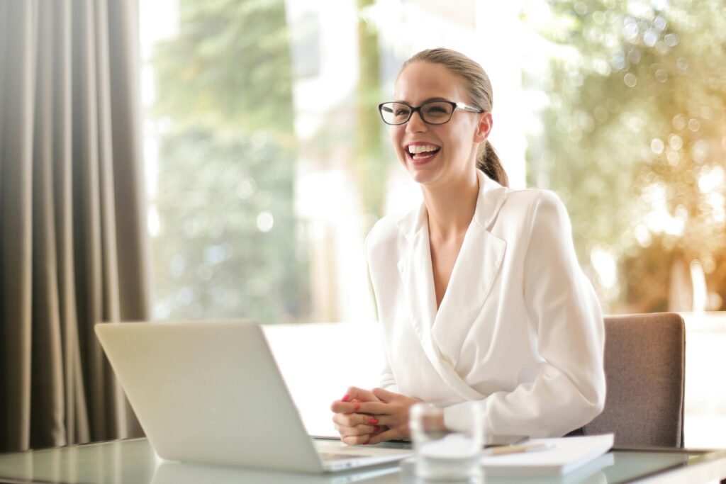 pexels-photo-3756679-3756679 Laughing businesswoman working in office with laptop