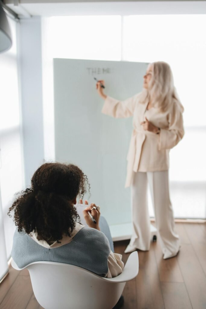 Back View of a Student Listening to Her Teacher